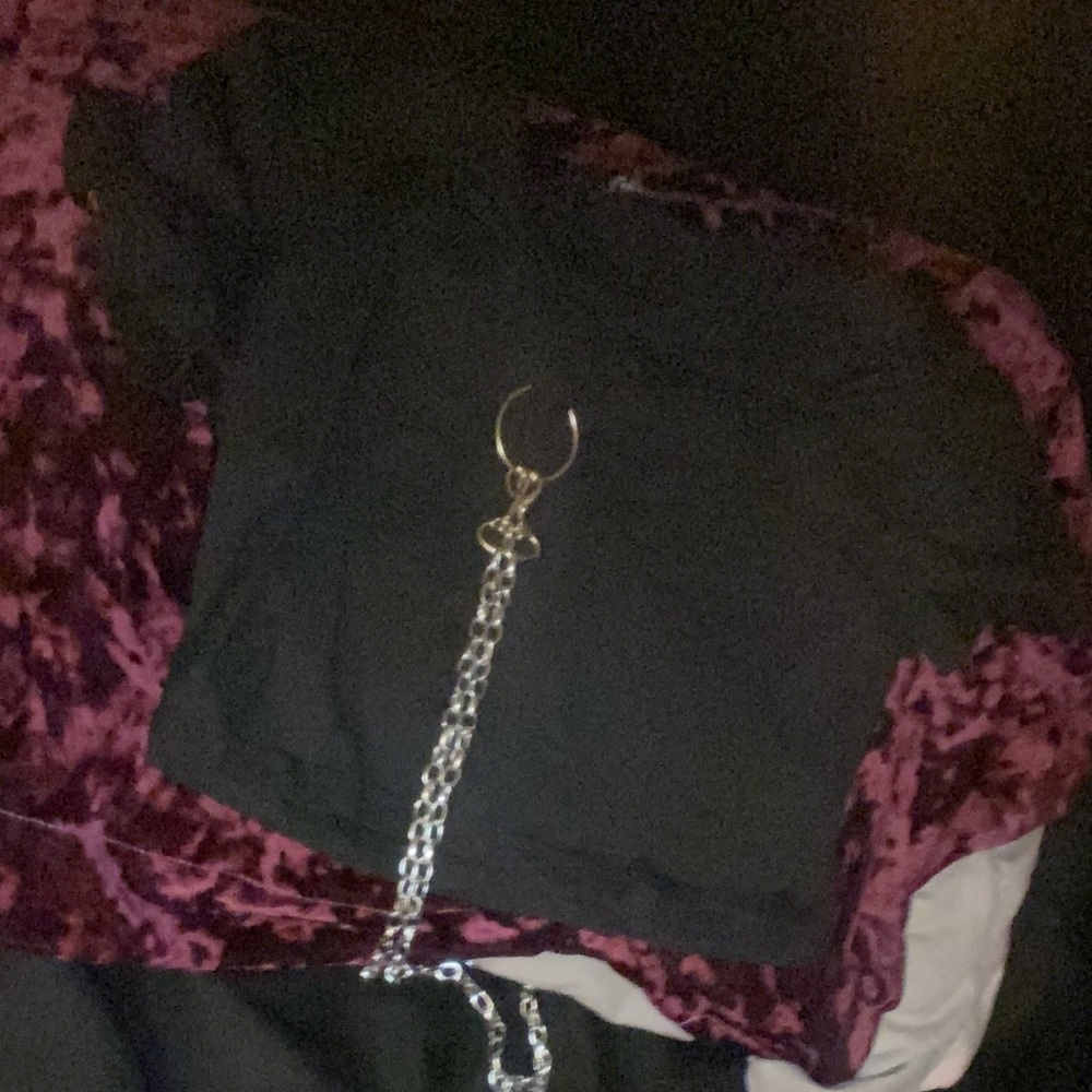 Black crop top with chain that lays around waist and stomach area